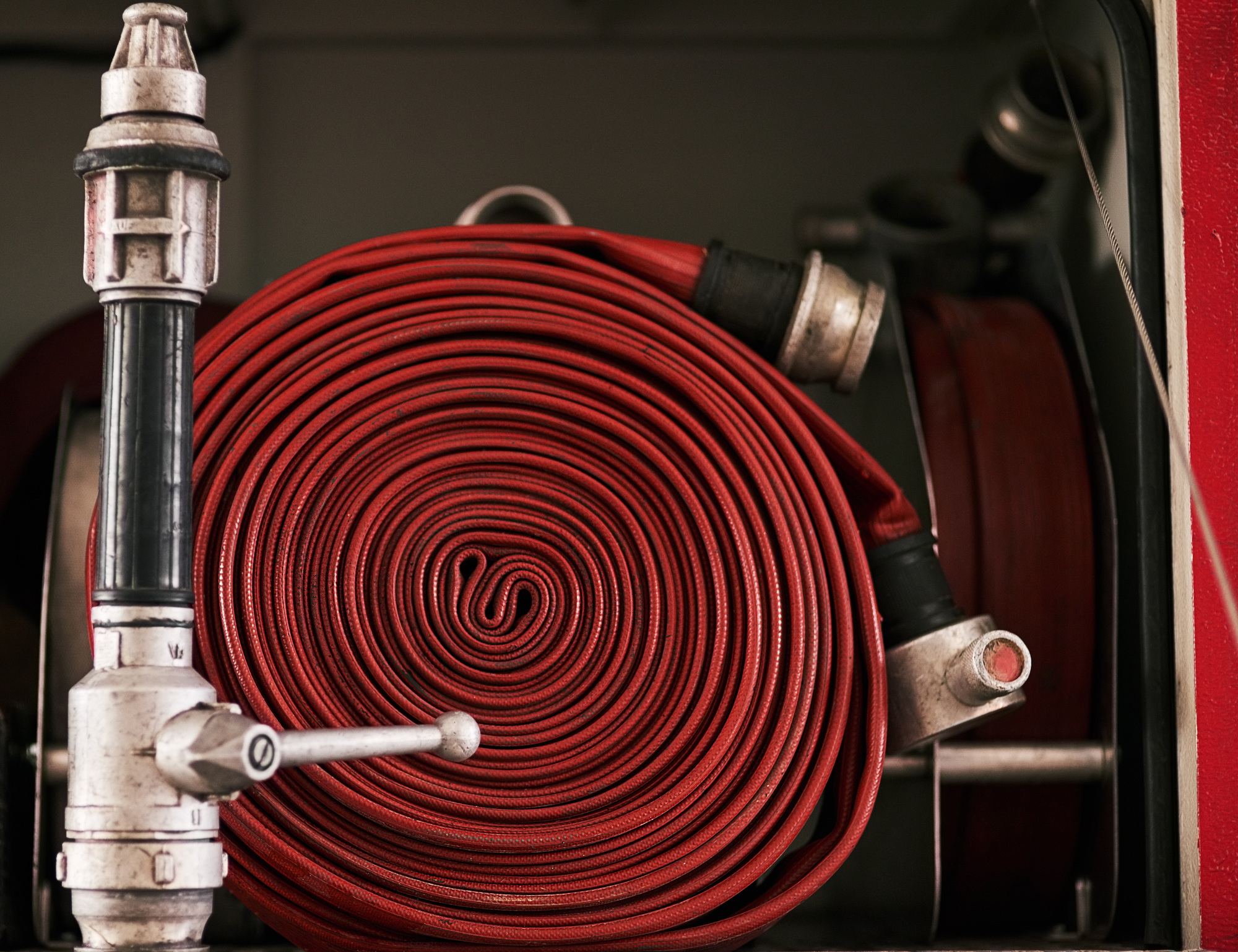 Behind the scenes at the fire station. Cropped shot of a coiled fire hose.